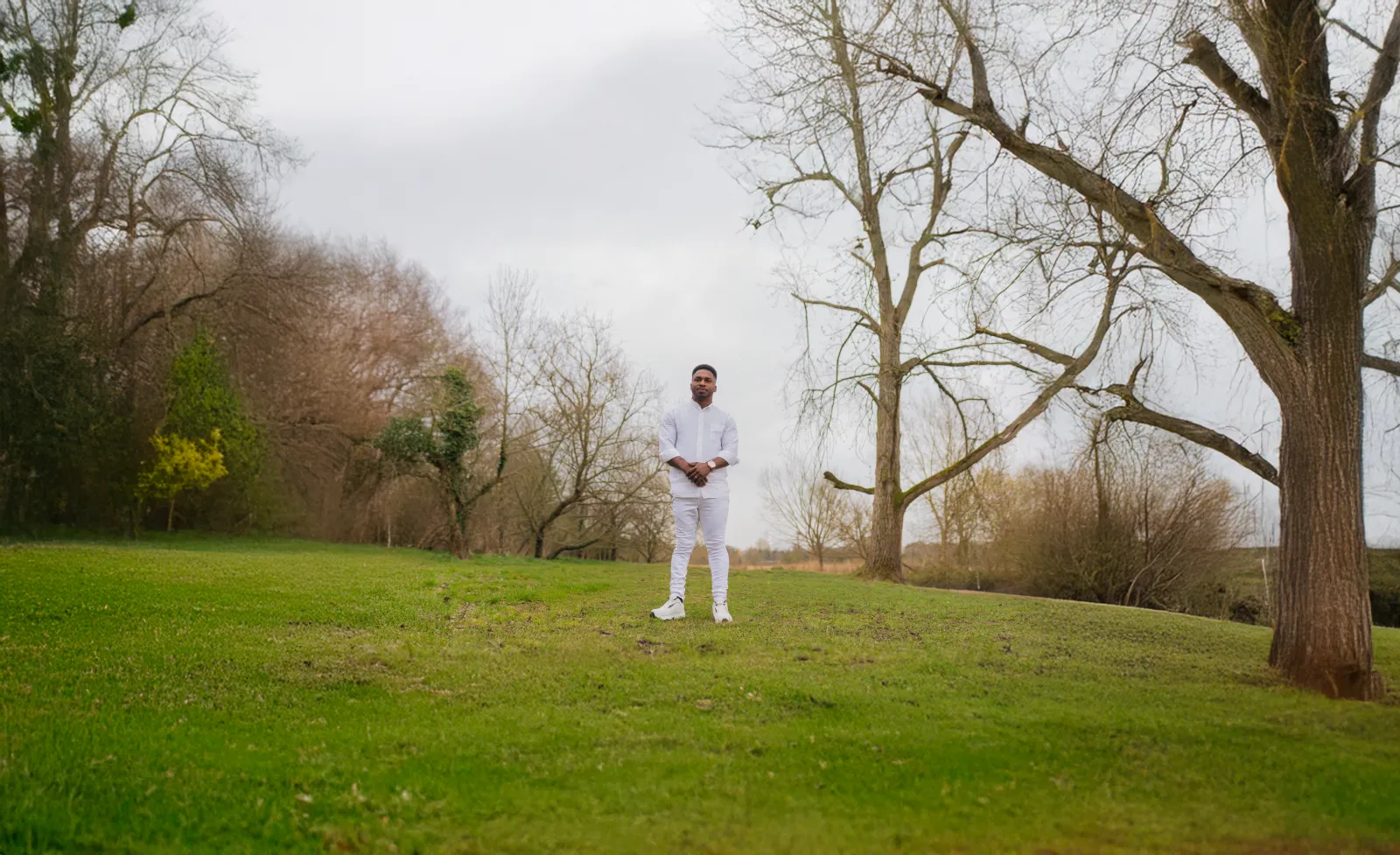 John Great standing in a quiet open landscape